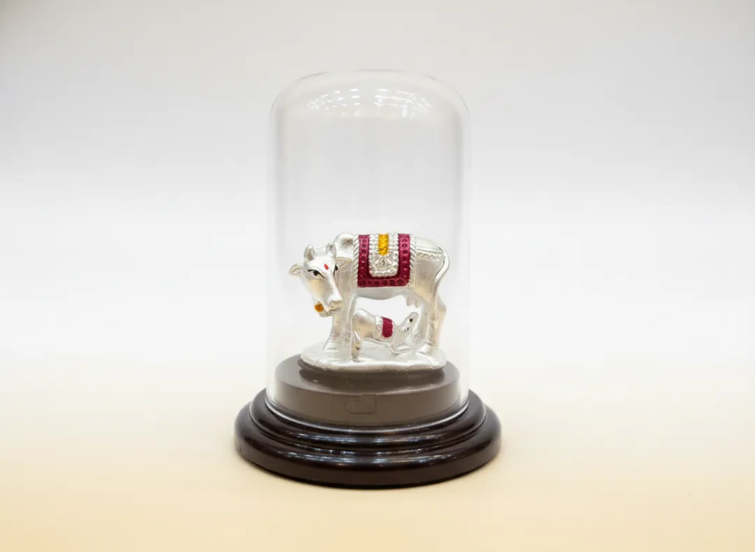 Pure 999 silver Kamdhenu cow and calf idol with meenakari enamel work in glass dome — BIS hallmarked, Swarn Shikhar Jewellers Chembur Mumbai