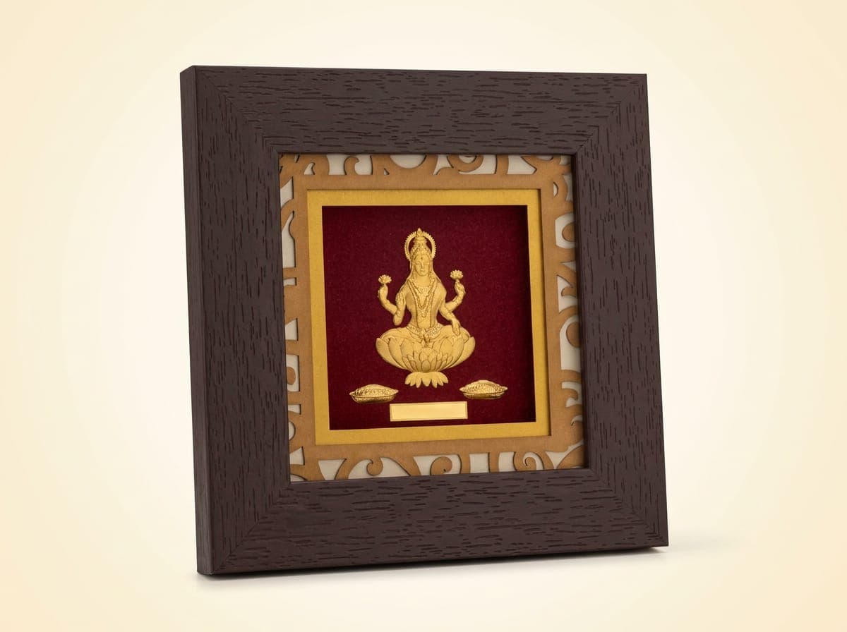 Golden Touch Lakshmi frame: embossed 24K gold leaf Lakshmi seated on a lotus on a maroon ground, inside a laser-cut gold mat and a square dark wood frame